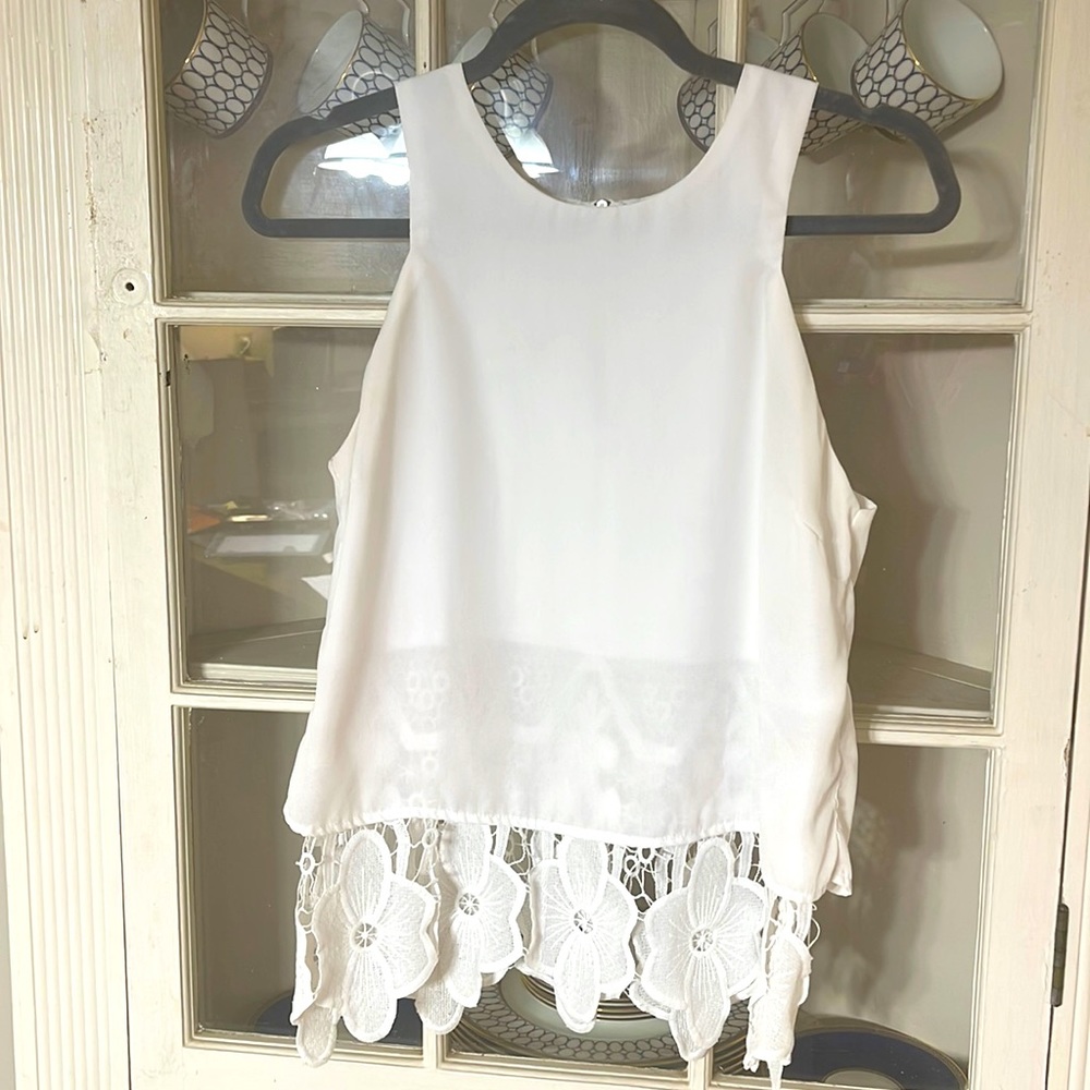 Cute tank with stitched floral underlay and zipper back.